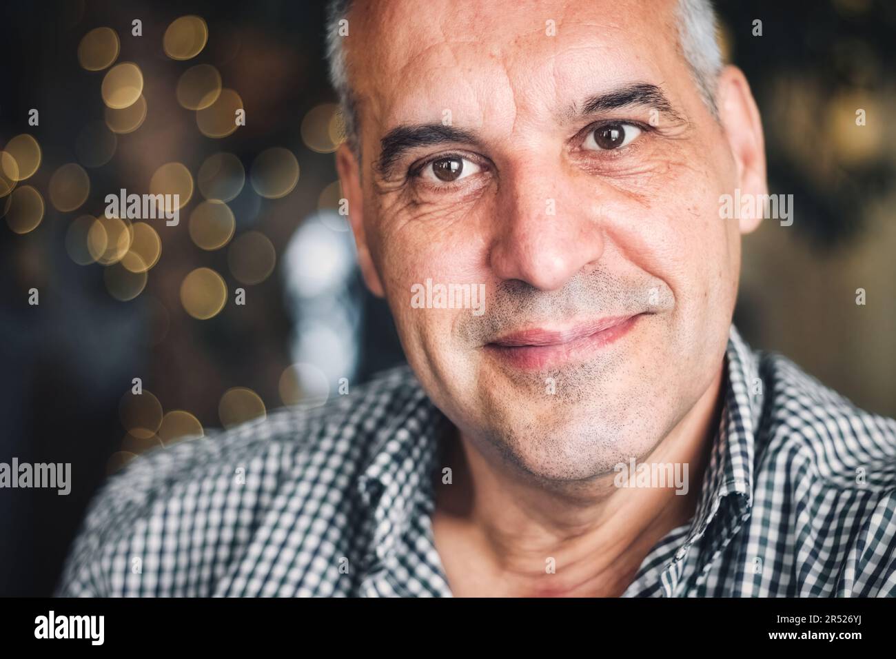 Primo piano ritratto di un uomo caucasico bianco di mezza età che sorride e guarda direttamente la fotocamera Foto Stock