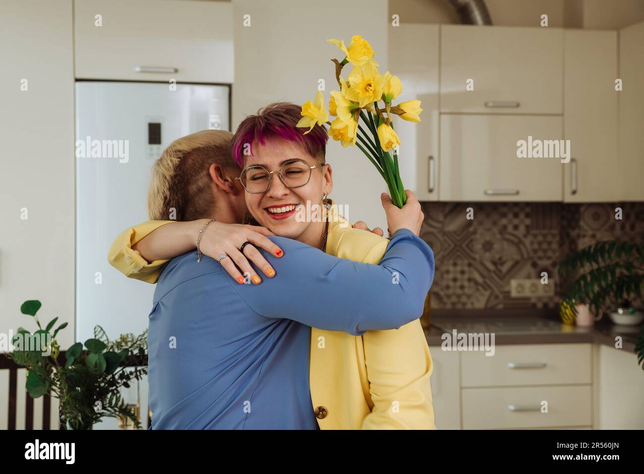 Abbracciare le generazioni: Figlia e madre abbracciano e gioiscono per il compleanno Foto Stock