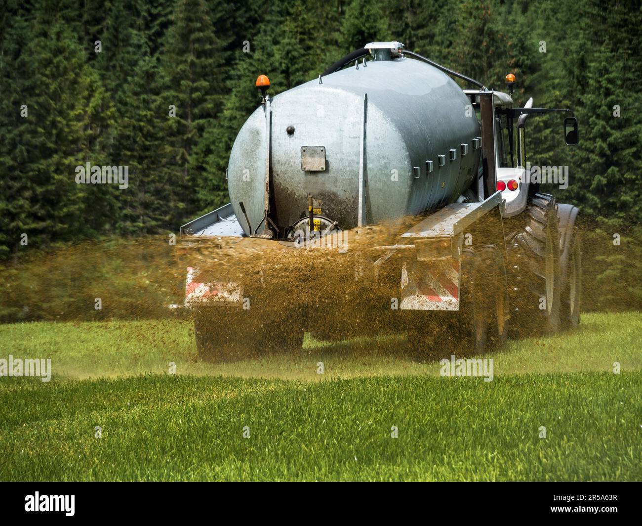 Un trattore che concima un campo con concime, Austria Foto Stock