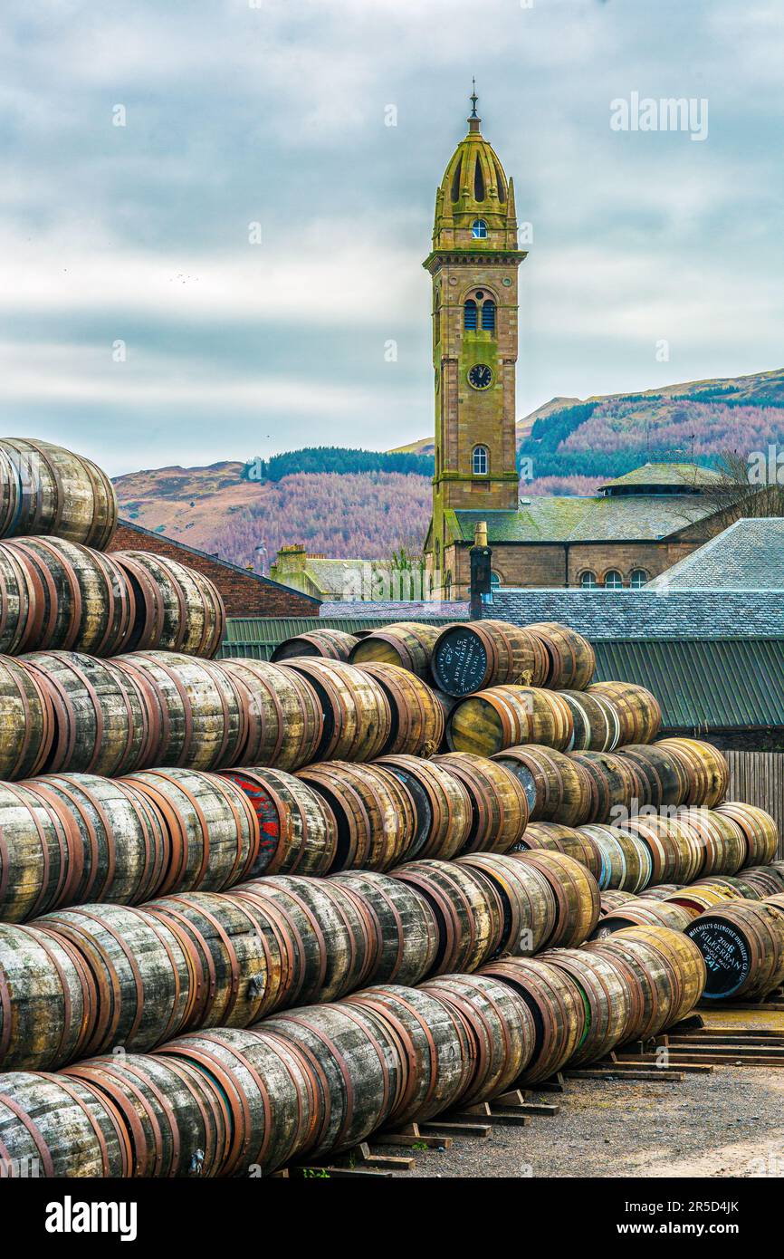 Botti di whisky con la Chiesa Parrocchiale delle Highland sullo sfondo , Campbeltown , Scozia Foto Stock