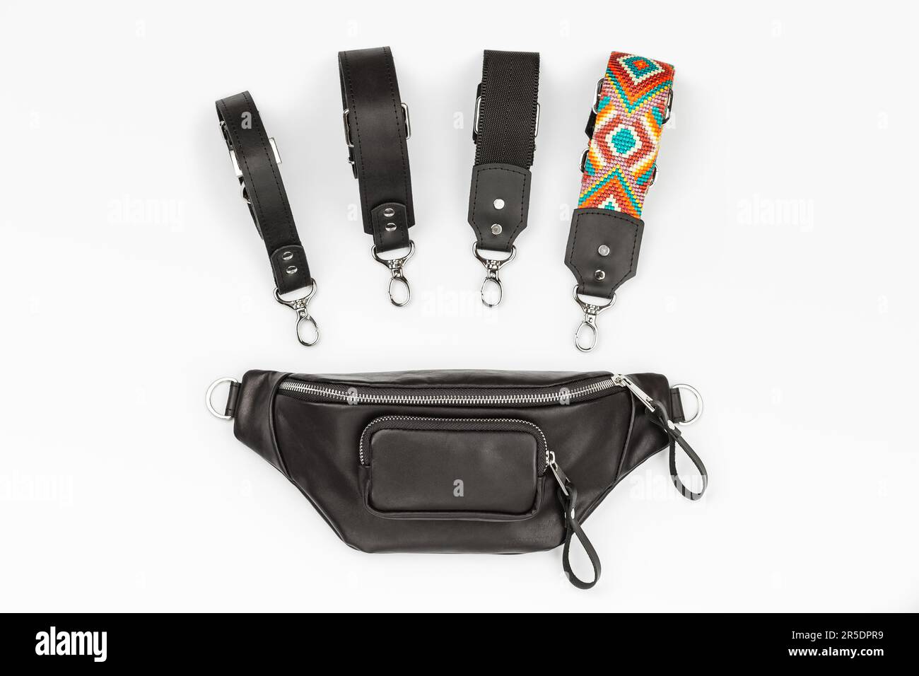 Pacchetto panana in vera pelle nera con tasca con zip e quattro tipi di cinghie attaccabili. Borsa piatta personalizzabile su sfondo grigio Foto Stock
