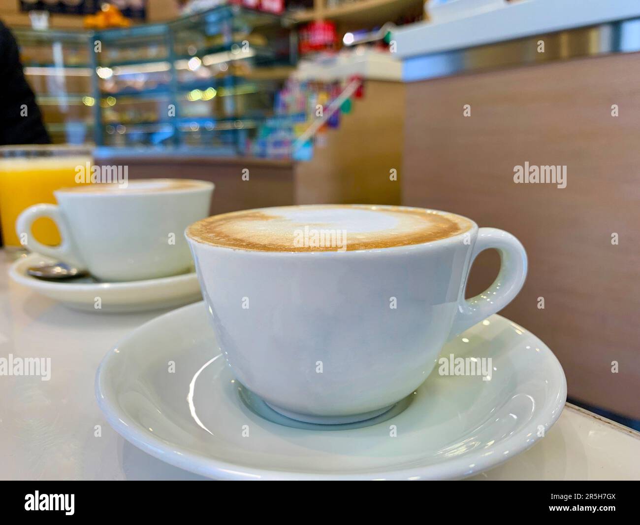 Una deliziosa fotografia ravvicinata con due tazze fumanti di cappuccino ricco e cremoso in un autentico caffè italiano. Le immagini accattivanti Foto Stock