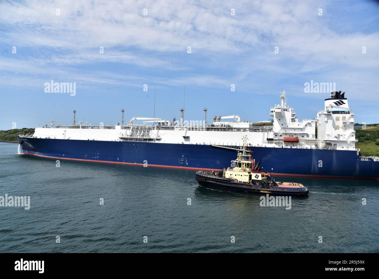 GASLOG HOUSTON una petroliera LNG raffigurata nel Milford Haven Waterway, Pembrokeshire Dock, Galles occidentale, ha anche raffigurato un rimorchiatore accanto al GASLOG HOUSTON Foto Stock