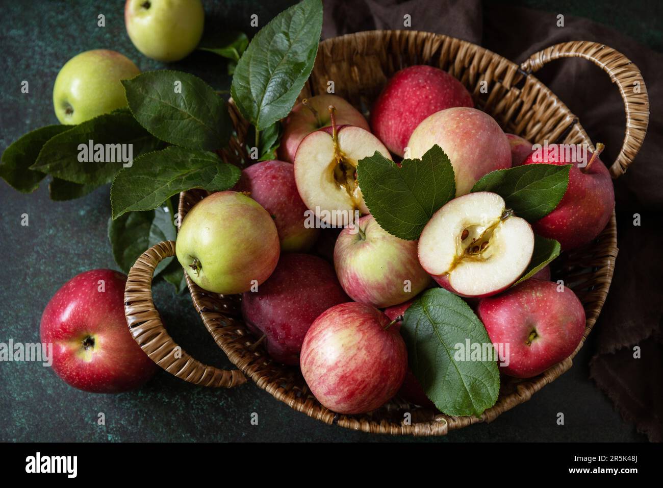 Frutta di fondo, frutta biologica. Cibo ancora vita. Cesto di mele mature su un tavolo di pietra. Foto Stock