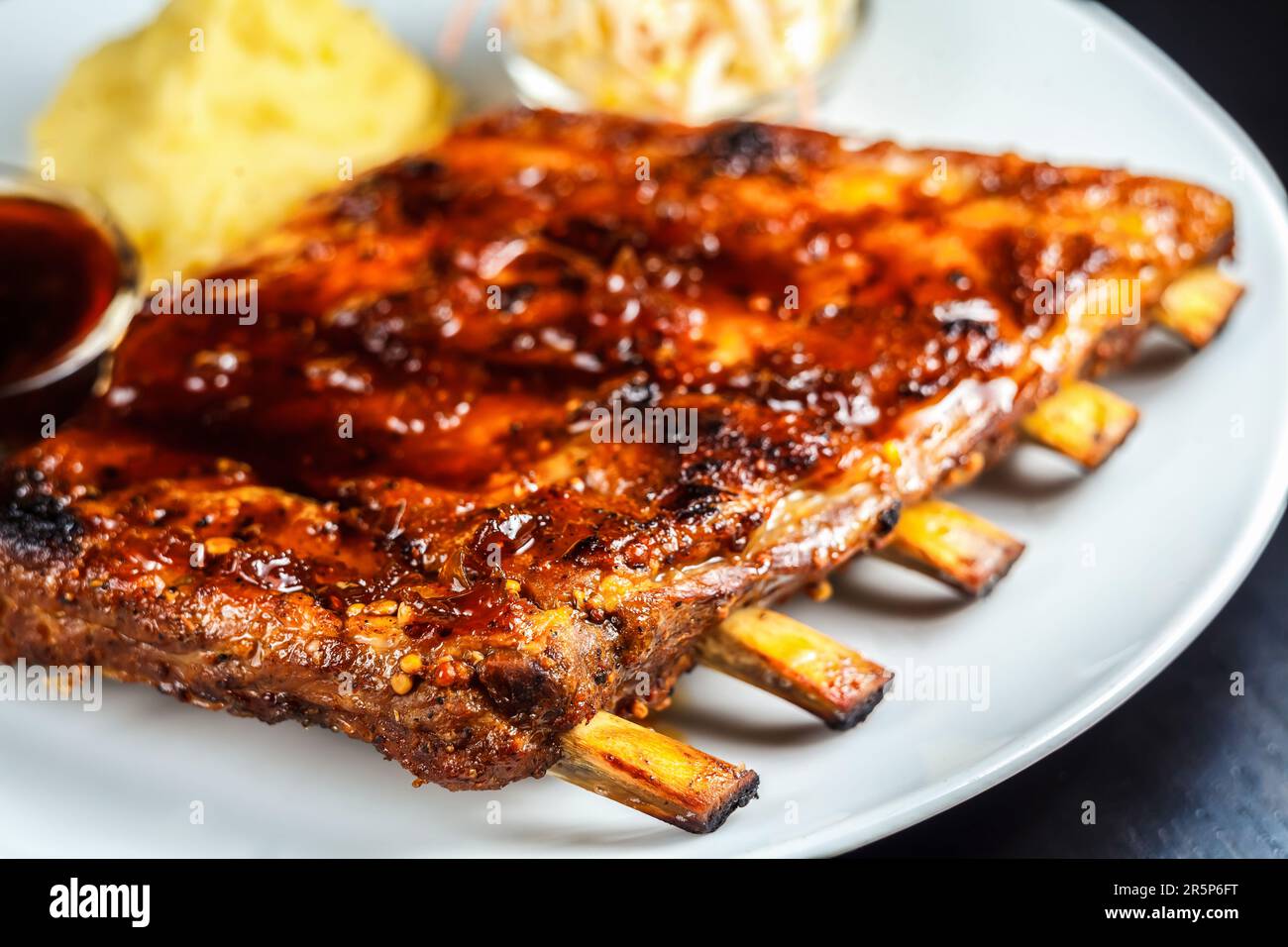 Gustose costolette grigliate alla perfezione e servite su un piatto, il pasto perfetto per ogni occasione! Foto Stock