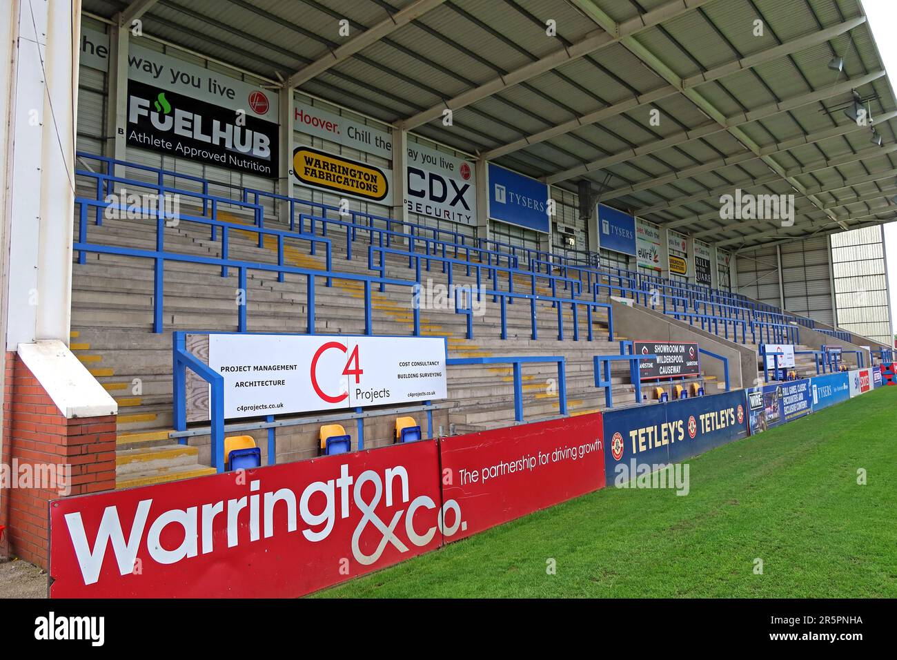 Posti a sedere sponsorizzati all'Halliwell Jones Stadium, sede del Warrington Wolves Rugby League Club, con il marchio Warrington & Co a Warrington Foto Stock