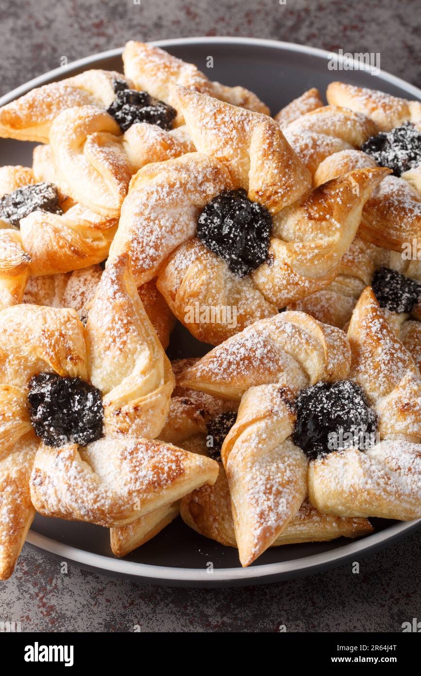 Torta di natale di joulutorttu a forma di stella finlandese con primo piano di marmellata essiccata in un piatto su un tavolo. Verticale Foto Stock