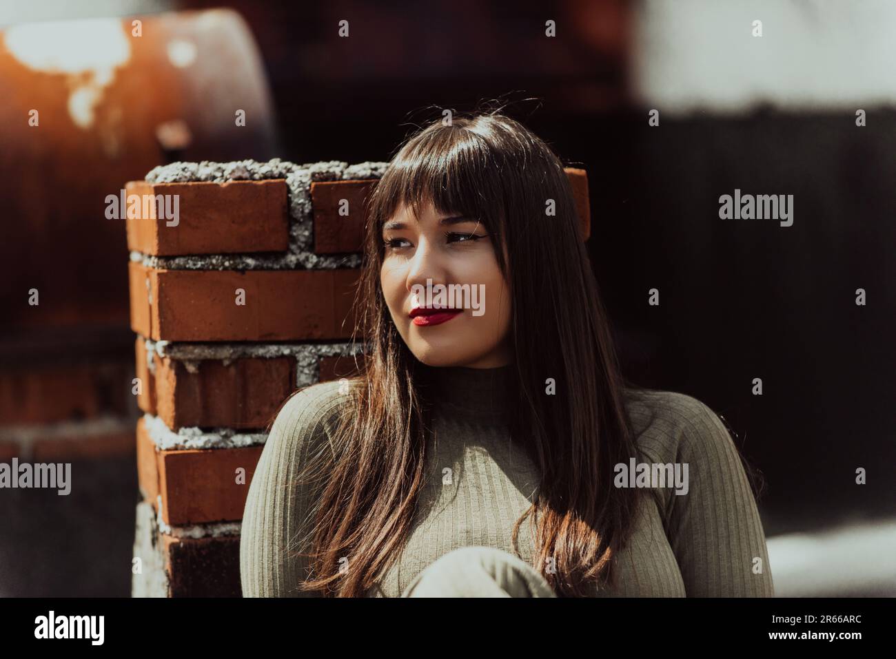 Una donna sicura ed elegante di più dimensioni che cammina in un edificio moderno in un vestito verde oliva, irradiando bellezza, empowerment, e l'amore di sé. Foto Stock