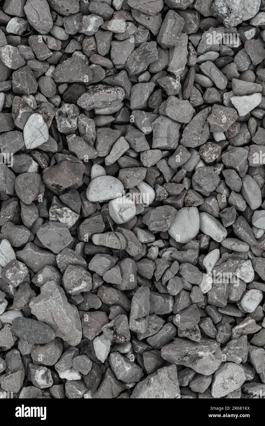 Consistenza di ghiaia sparsa sul terreno Foto Stock
