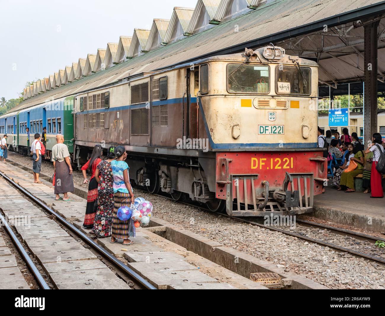 Treno passeggeri e passeggeri in attesa a Yangon Central, la stazione ferroviaria principale di Yangon, Myanmar. Foto Stock