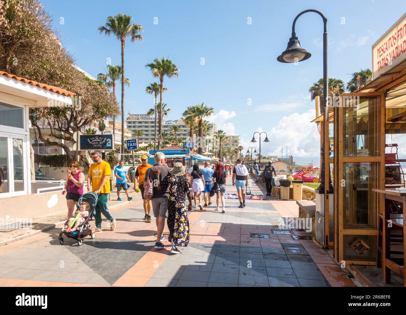 Affollato lungomare, turisti a piedi lungo il passaggio pedonale, spiaggia di Carihuela, Torremolinos, Costa del Sol, Spagna. Foto Stock