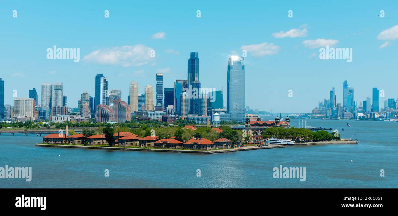 Una vista panoramica di Ellis Island, Stati Uniti, fin dalla baia, con il centro di Jersey City sulla sinistra e Lower Manhattan, a New York City, ON Foto Stock