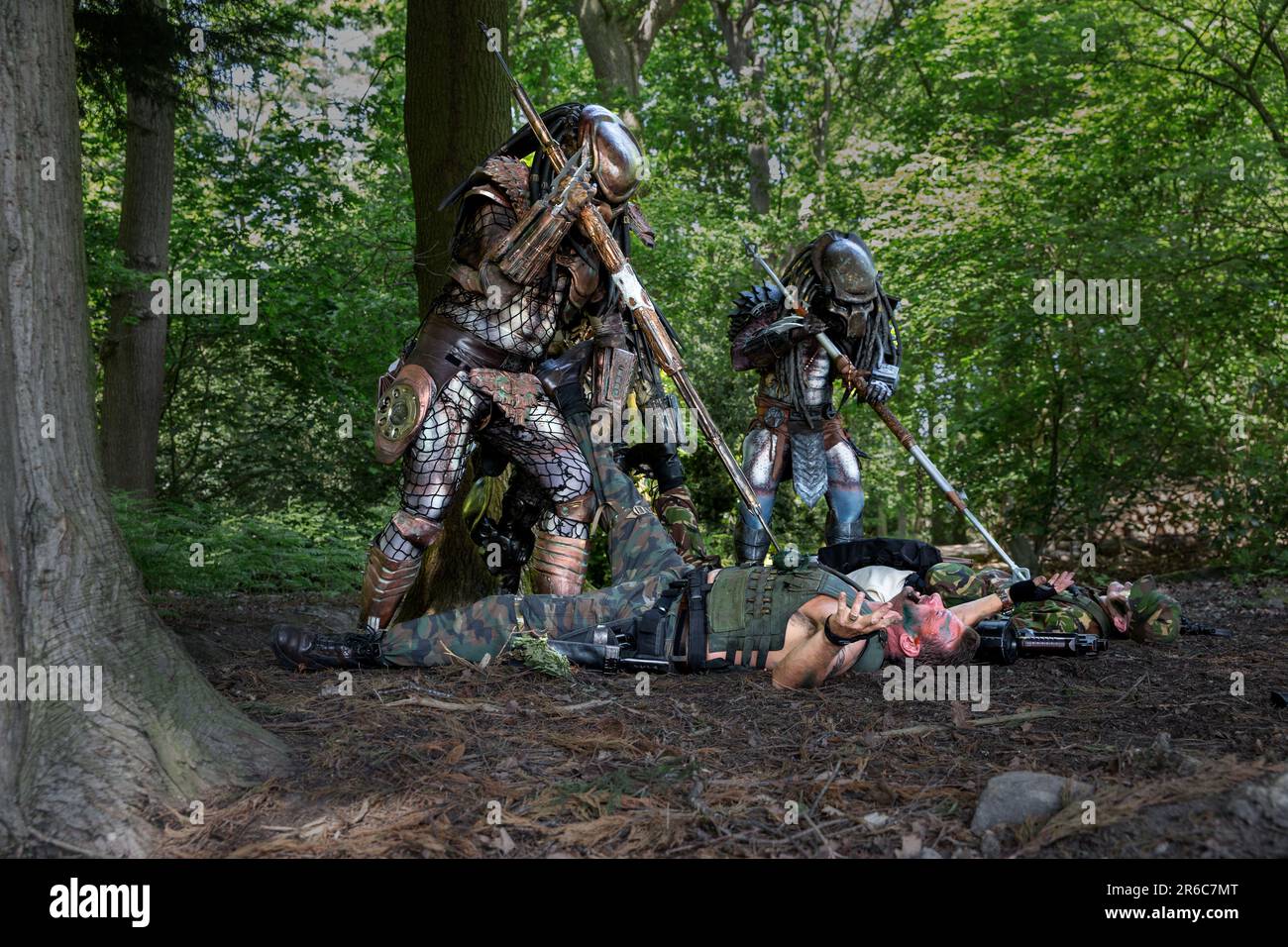 HARROGATE, REGNO UNITO - 3 GIUGNO 2023. Un ritratto di un cosprayer vestito come un Predator alieno in costume realistico all'aperto in un ambiente boschivo Foto Stock