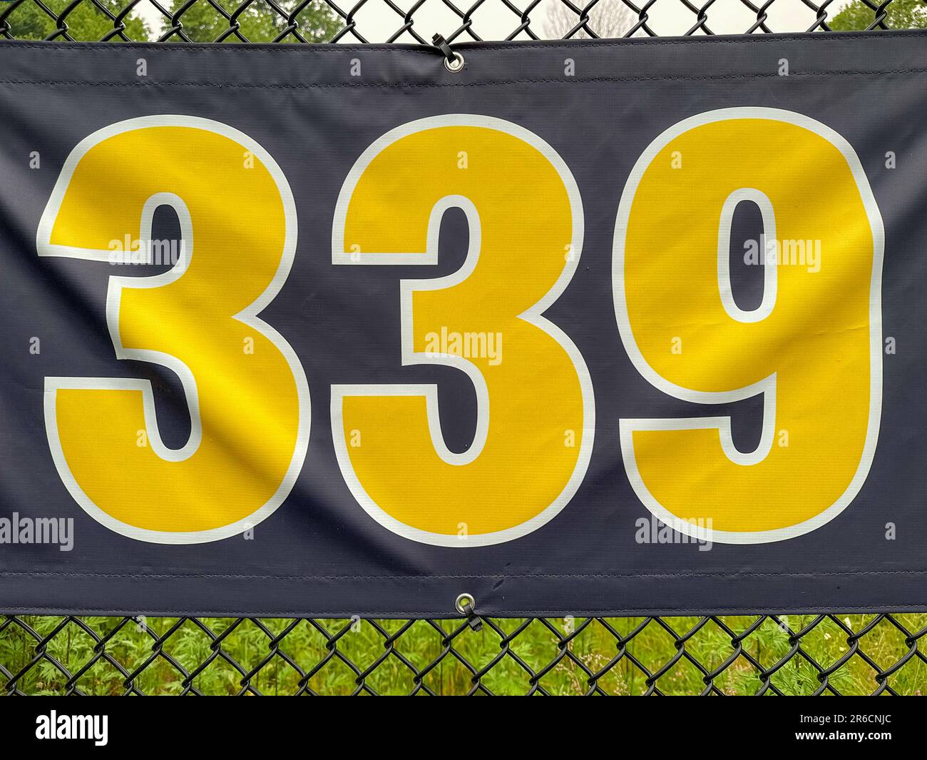 339 piedi ft campo da baseball segno di distanza in giallo e nero montato sulla recinzione di vinile nero. Foto Stock