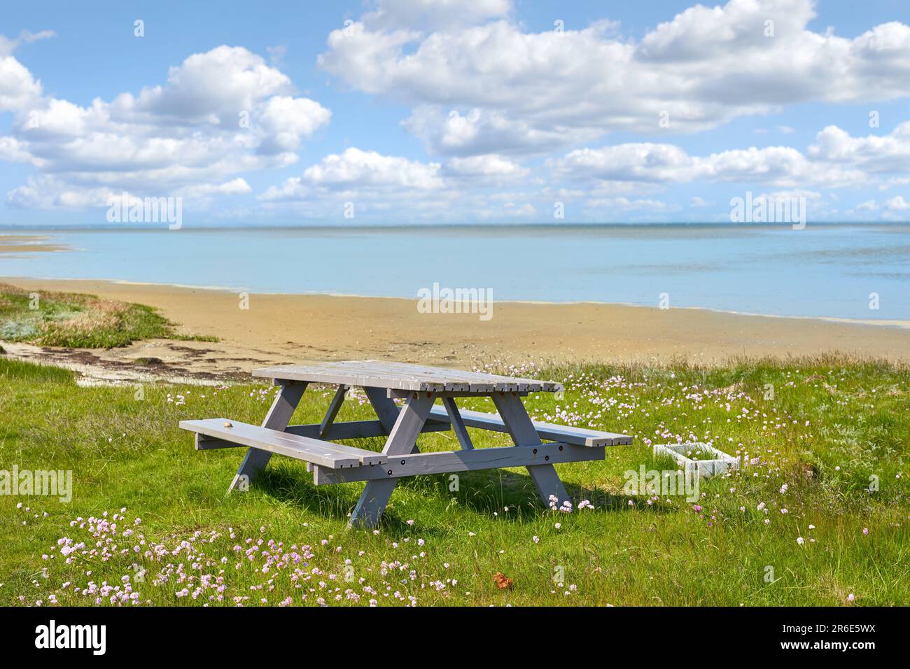 Tavolo da picnic, spiaggia e paesaggio con natura e viaggi, ambiente e località costiera in Danimarca. Vista sull'oceano, aria fresca e paesaggi naturali Foto Stock