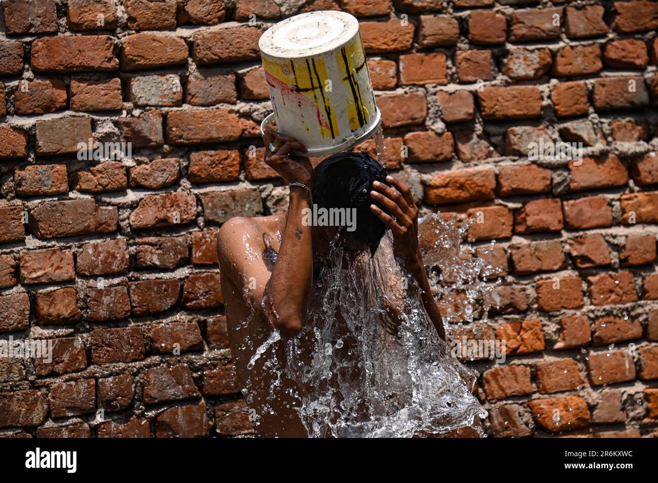 Nuova Delhi, Delhi, India. 10th giugno, 2023. Un uomo si bagna con un secchio d'acqua in una calda giornata estiva a Nuova Delhi, India, il 10 giugno 2023. (Credit Image: © Kabir Jhangiani/ZUMA Press Wire) SOLO PER USO EDITORIALE! Non per USO commerciale! Credit: ZUMA Press, Inc./Alamy Live News Foto Stock