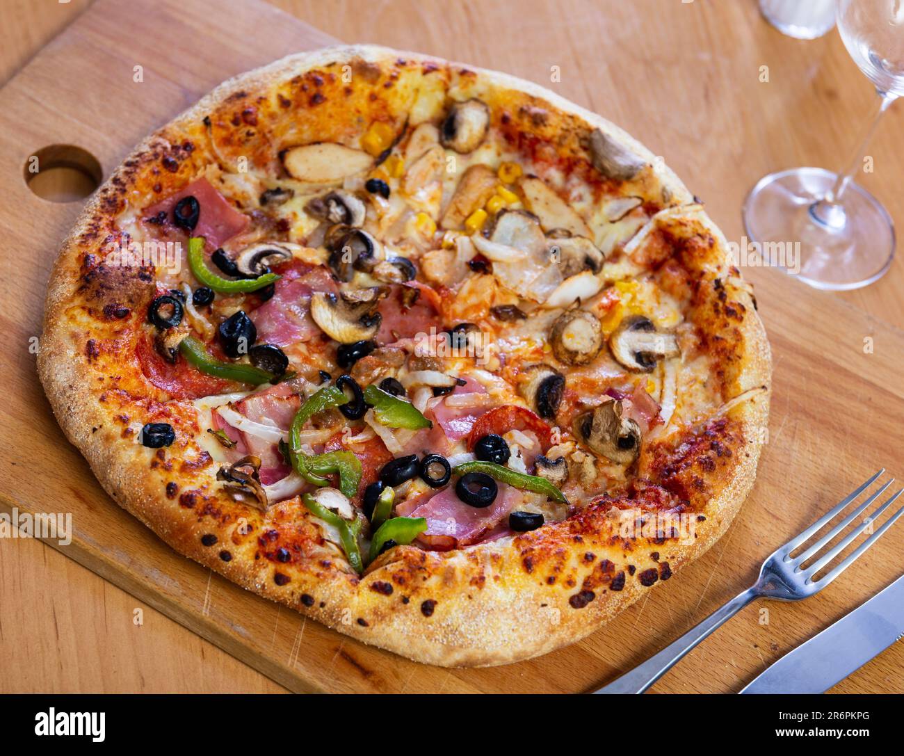 Pizza doppia servita su tavola di legno Foto Stock