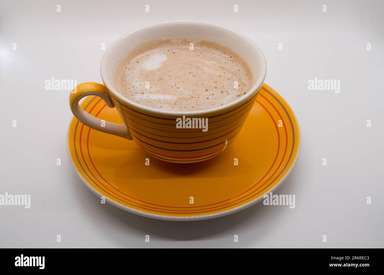 Tazza di caffè gialla e piatto isolato su sfondo bianco. Con tracciato di ritaglio Foto Stock