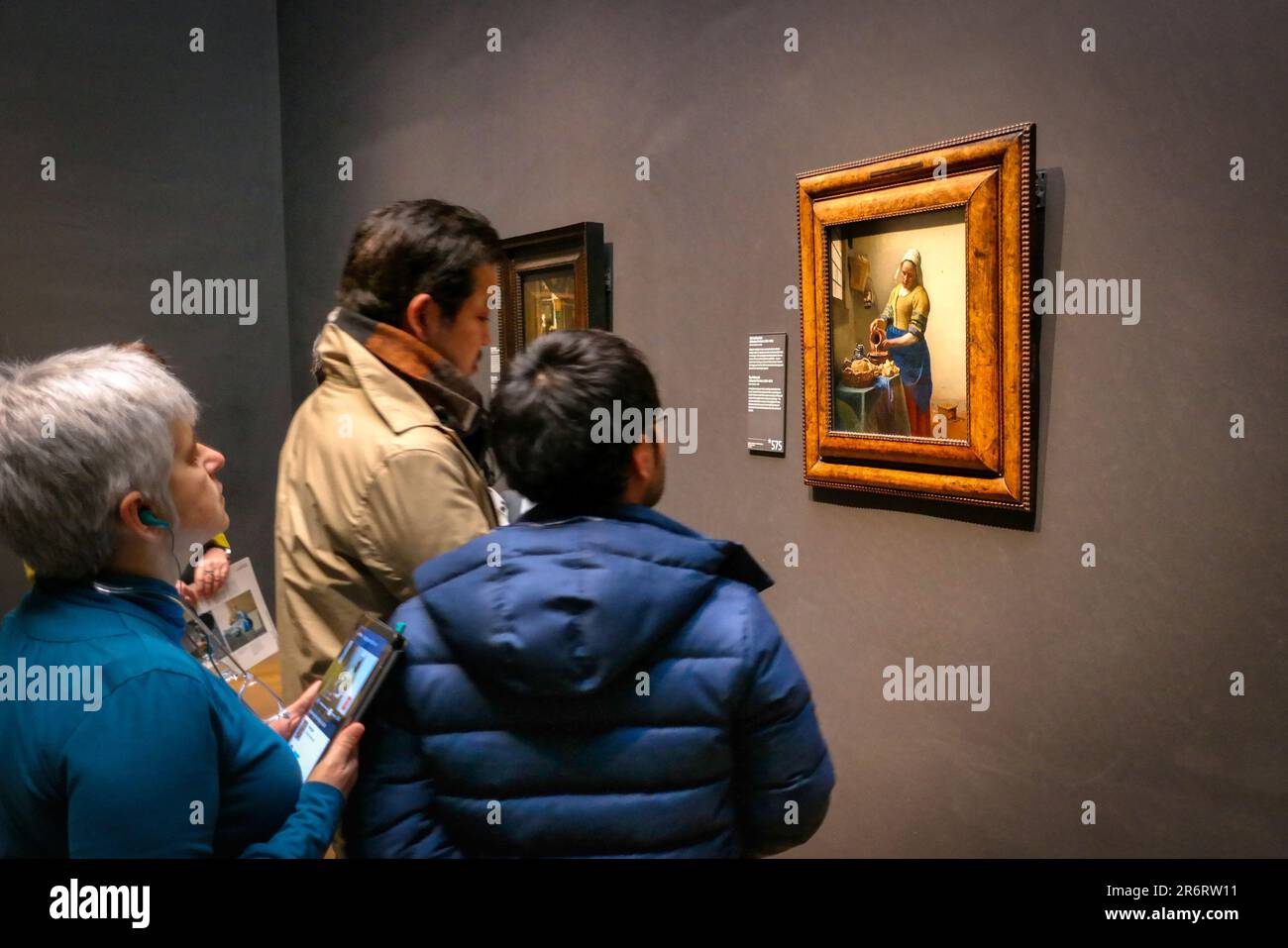 Visitatori del Rijksmuseum di Amsterdam, guardando il dipinto di Vermeer "la Milkmaid" Foto Stock