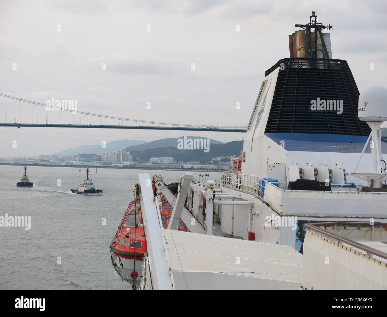 Ammira dal ponte una nave da crociera mentre naviga sotto il ponte Ulsan, con partenza dal porto di Ulsan, in Corea del Sud. Foto Stock