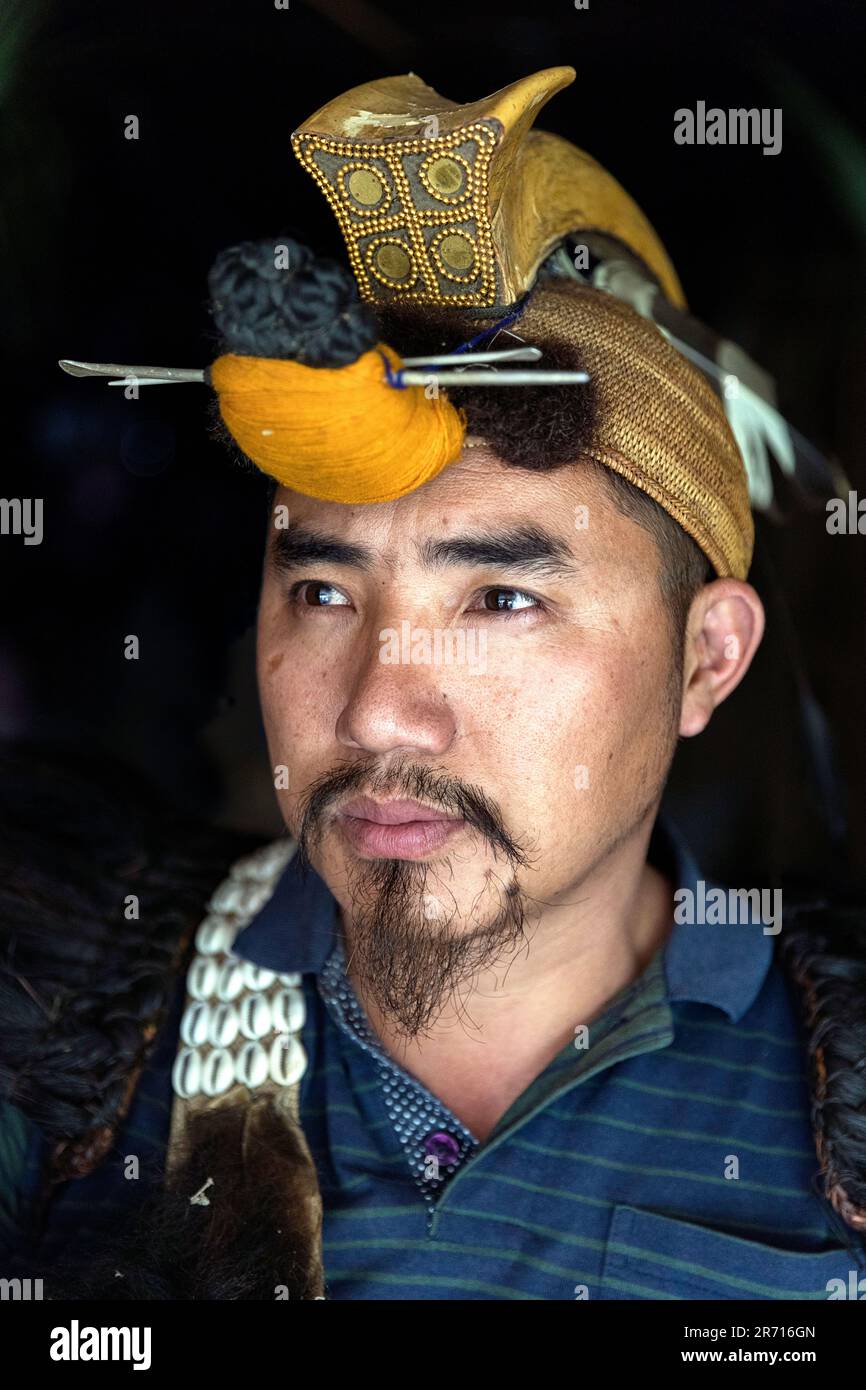 Ritratto di un giovane Nishi che indossa un costume da testa tradizionale, tra cui il becco dell'uccello Hornbill, Arunachal pradesh, India nord-orientale Foto Stock