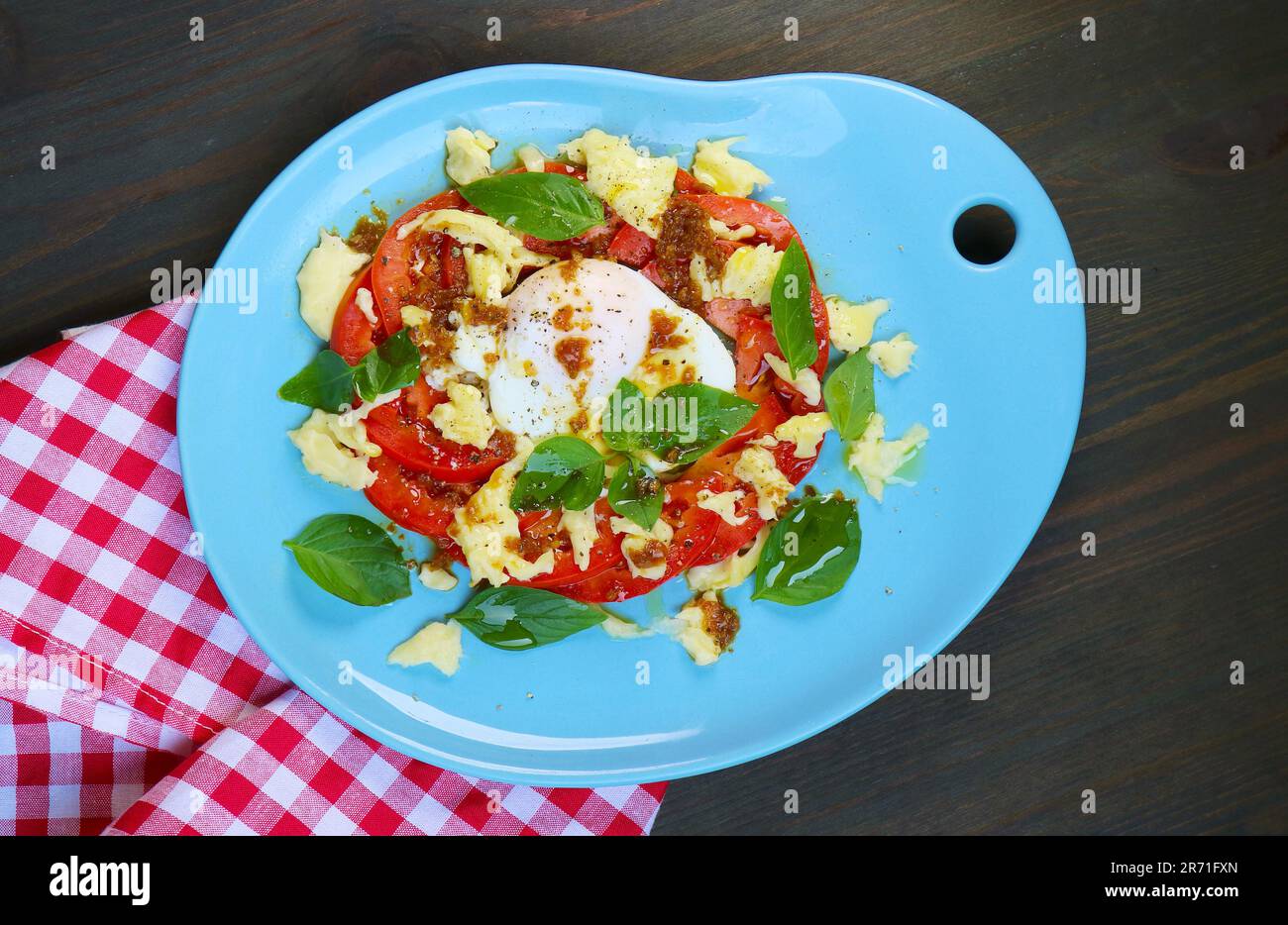 Deliziosa insalata caprese fatta in casa con un uovo in camicia Foto Stock