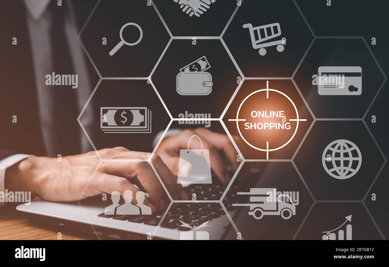 Uomo d'affari che utilizza il laptop con l'icona del carrello, lo shopping online e il concetto di e-commerce. Foto Stock