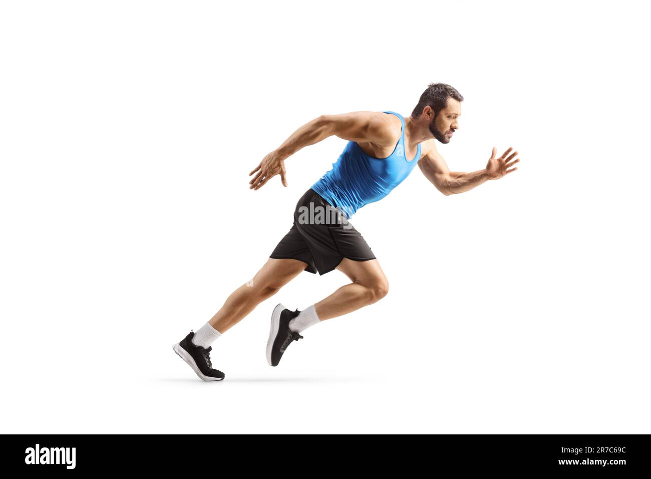 Profilo a tutta lunghezza di un uomo in forma che inizia una corsa isolata su sfondo bianco Foto Stock