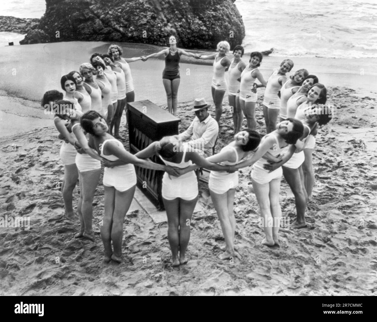 Santa Monica, California: 1925. Un balletto Albertina Rasch che prova sulla spiaggia con Dimitry Tiomkin al pianoforte al centro del gruppo. Foto Stock