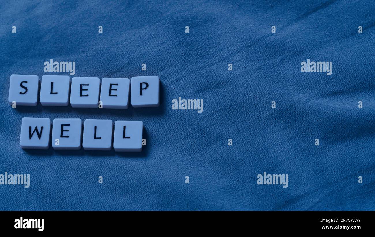 Dormi bene le parole su un soffice letto. Concetto di salute del sonno. Copia spazio per il testo. Foto Stock