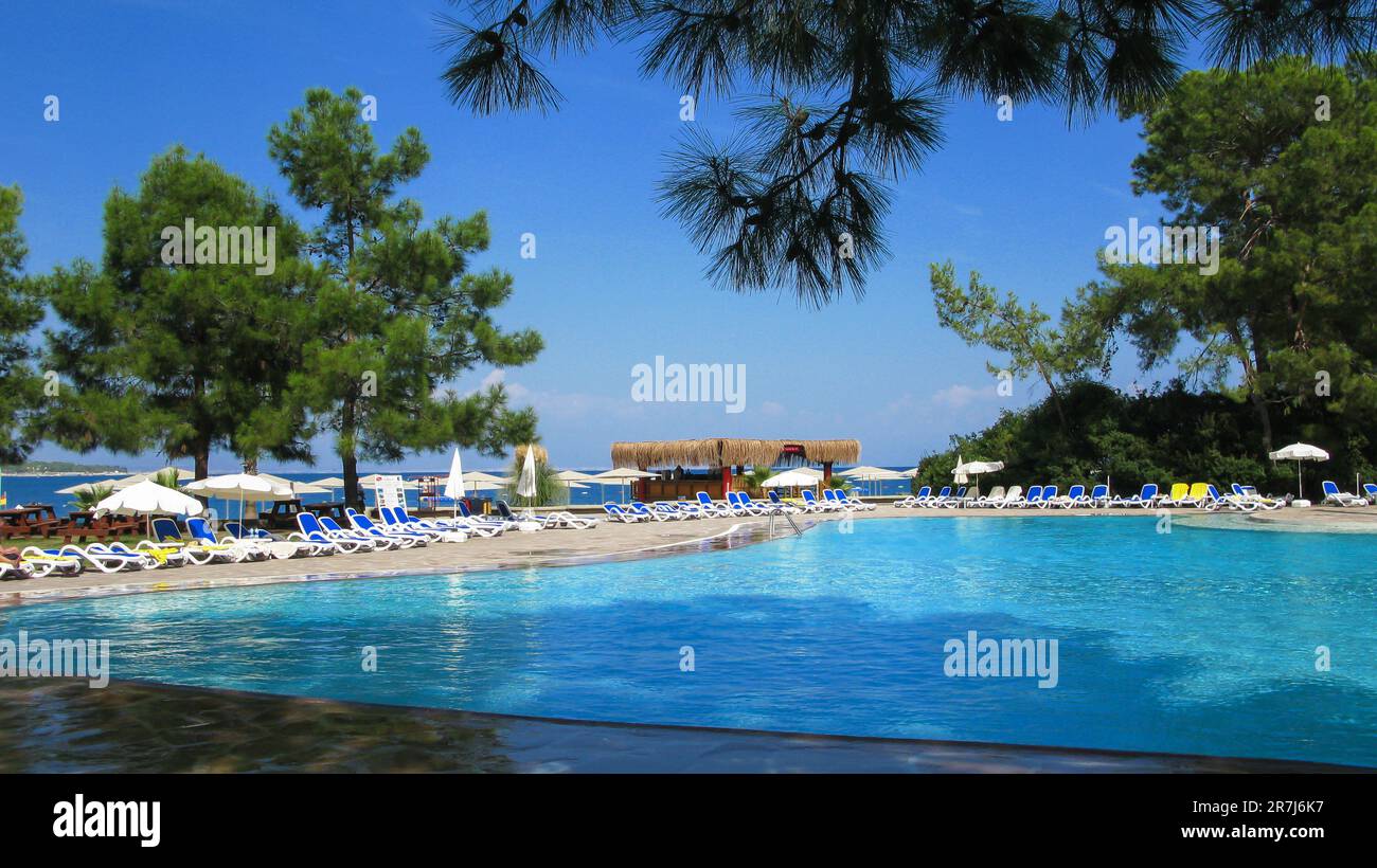 piscina d'acqua blu sul mare circondata da alberi sempreverdi Foto Stock