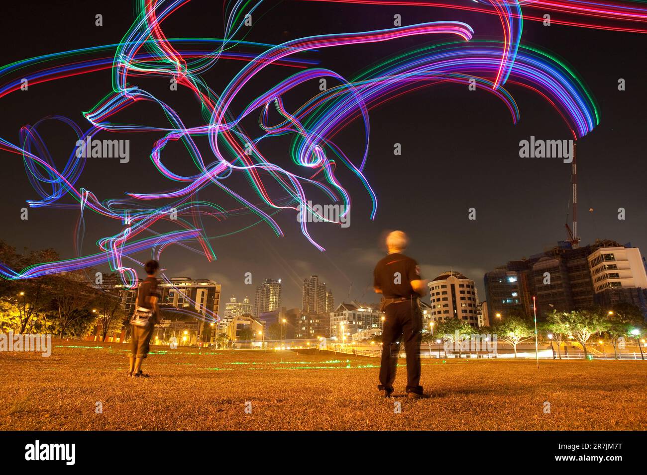 I membri del club Kite del Singapore Night Flyer illuminano il cielo serale con aquiloni telecomandati adornati da luci LED colorate. Foto Stock