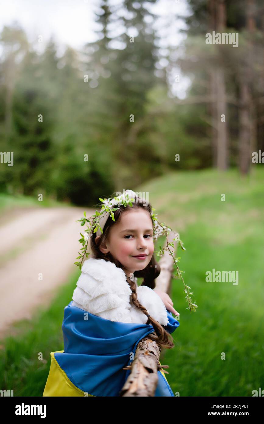 Ragazza Ucraina bambino con la bandiera di Ucraina nella foresta Foto Stock