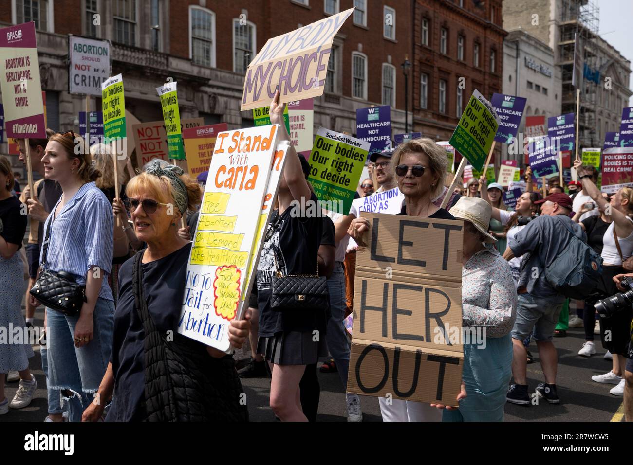 I manifestanti sono in possesso di cartelli che esprimono la loro opinione durante la manifestazione. I manifestanti e gli attivisti femministi del British Pregnancy Advisory Service (BPAS), Women's Equality e della Fawcett Society si riuniscono per protestare contro una recente sentenza del tribunale di imprigionare una madre di tre, Carla Fosters, per usare le pillole abortive sotto l'iniziativa governativa "pills by post" per gravidanze indesiderate da 32 a 34 settimane. L’iniziativa “pills by post” che è stata lanciata sulla scia della crisi di Covid ed è ancora in funzione per gravidanze indesiderate fino a 10 settimane. Foto Stock