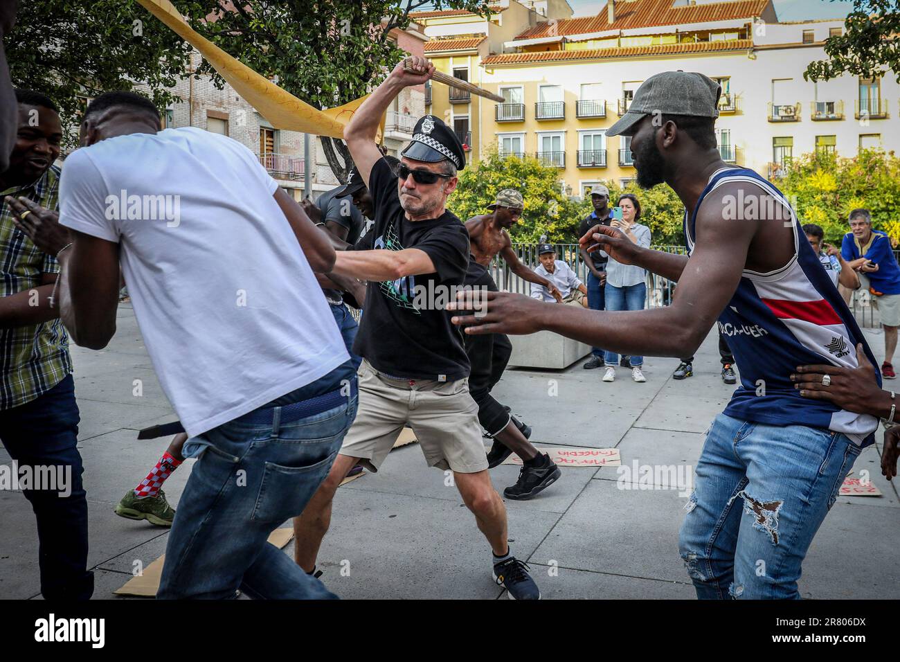 Madrid, Spagna. 17th giugno, 2023. Un paio di uomini simulano uno scontro tra immigrati e poliziotti durante una delle rappresentazioni teatrali che si tengono nelle strade del centro di Madrid. Diverse associazioni di immigrati del quartiere Lavapiés hanno rappresentato diverse performance nel pomeriggio di sabato 17 giugno per onorare i 73 immigrati uccisi a Melilla il 24 giugno 2022, dove si sono anche trovati 77 dispersi e 233 feriti. (Foto di David Canales/SOPA Images/Sipa USA) Credit: Sipa USA/Alamy Live News Foto Stock