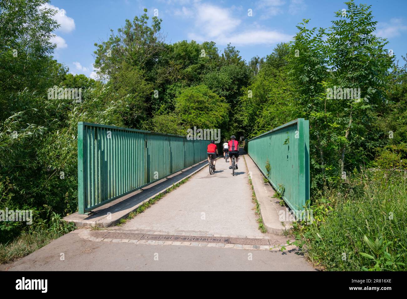 Ciclisti che attraversano il fiume Tame al Red Dish vale Country Park, Stockport, Greater Manchester, Inghilterra. Foto Stock