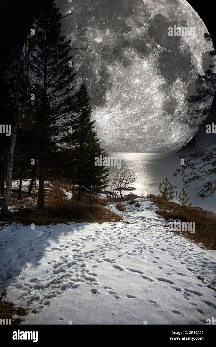 Composto di due foto - Luna piena (dominio pubblico della NASA) e un paesaggio notturno in inverno lungo la North Shore del Lago superiore, Minnesota, USA Foto Stock