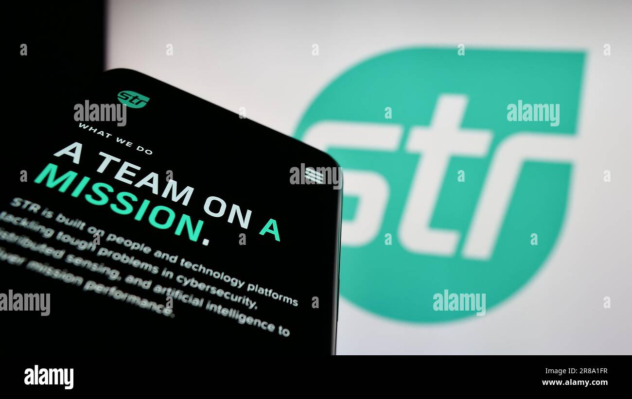 Telefono cellulare con sito Web di Systems and Technology Research LLC (STR) sullo schermo davanti al logo aziendale. Mettere a fuoco in alto a sinistra sul display del telefono. Foto Stock