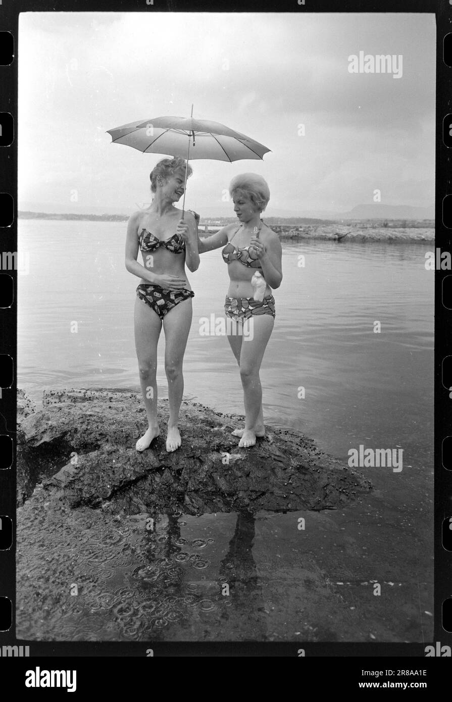Attuale 33-5-1960: Marrone senza sole ora una nuova preparazione è disponibile per l'acquisto qui in Norvegia - un liquido che si striscio su in modo che si ottiene un abbronzatura durante la notte. Abbiamo fatto un esperimento e potete studiare i risultati nelle immagini. Dopo otto ore, la Marit oliata era dorata, ma aggiungiamo che si è rivelata un'abbronzatura costosa. Per il trattamento sono state utilizzate circa tre bottiglie, ciascuna delle quali costa 12 NOK. Era gocciolante e il sole era lontano dalle nuvole quando il primo cappotto fu posato alle 12. Marit (a sinistra) la voltò di nuovo a Brittan e la lasciò sola. Se la panacea mantenesse la sua promessa Foto Stock