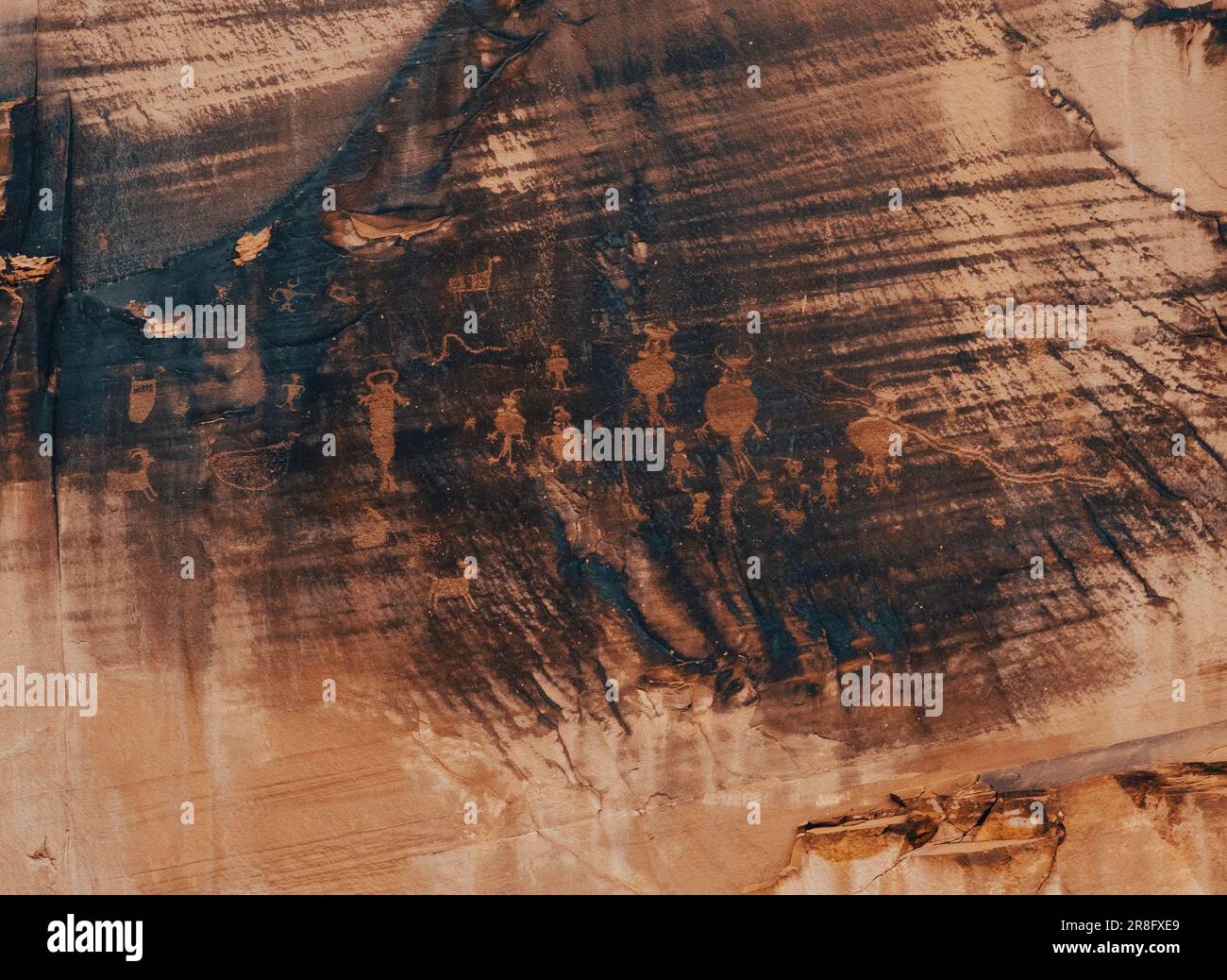 Antichi petroglifi di origine sconosciuta adornano il lato di un isolato muro del canyon, visibile solo dalla storica Potash Road Foto Stock