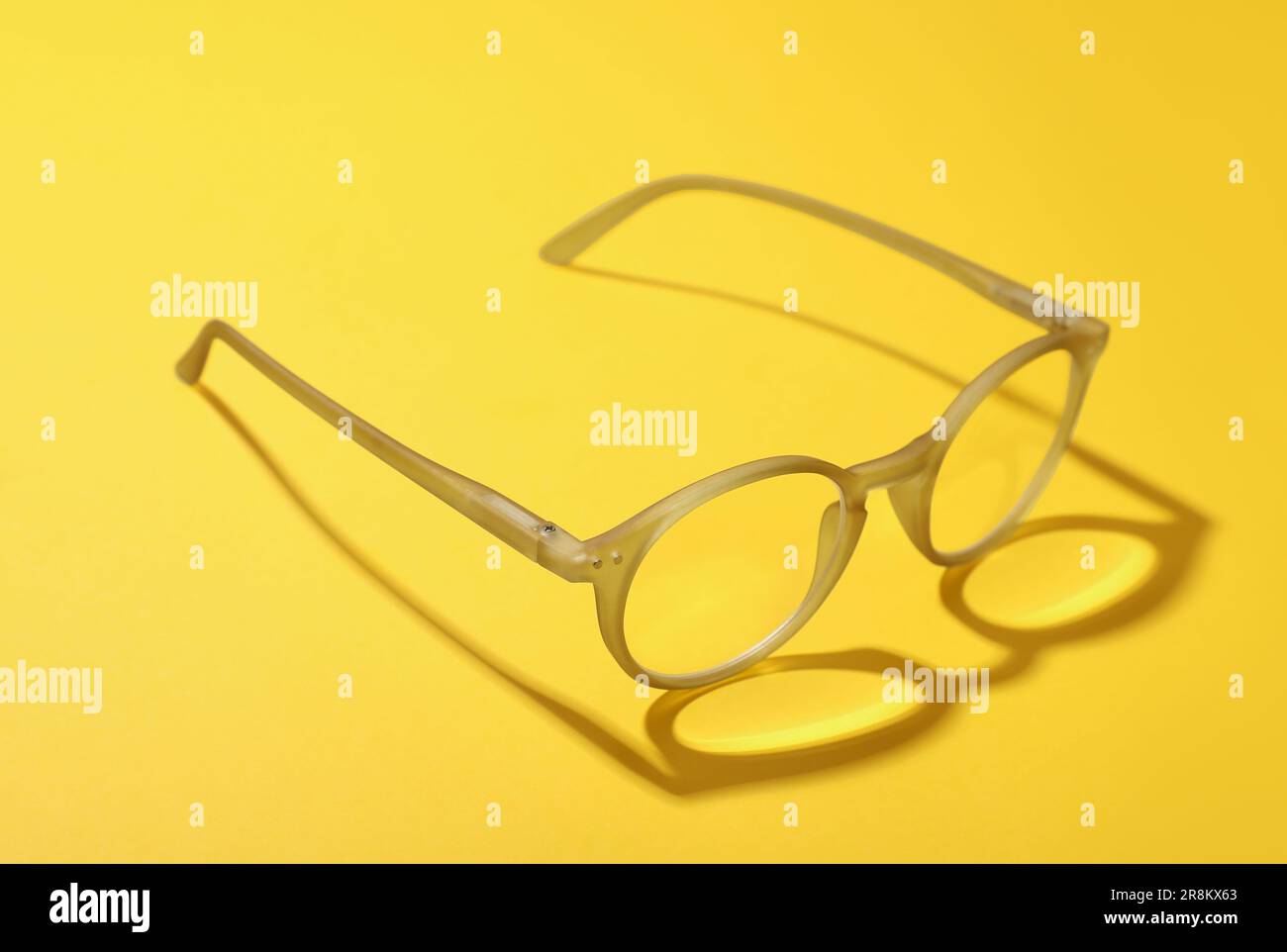 Occhiali con lenti correttive su sfondo giallo Foto Stock