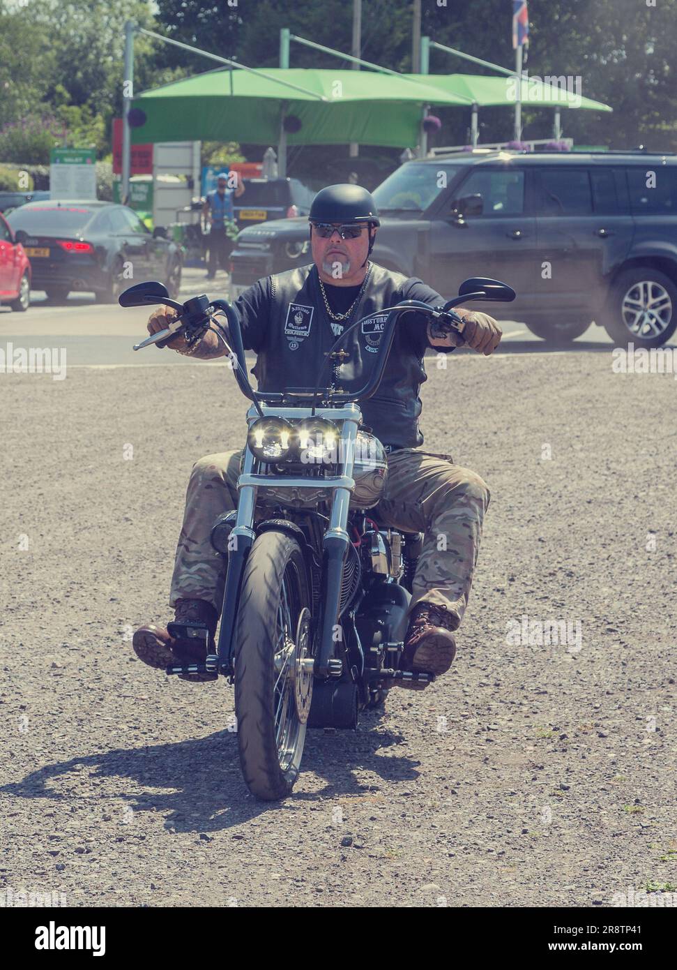 Membri di un Motorcycle Club che arrivano a un raduno motociclistico. Un motociclista che arriva a un raduno motociclistico. Foto Stock