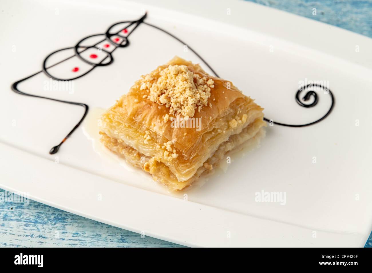 Baklava turca con nocciole su un piatto di porcellana bianca Foto Stock