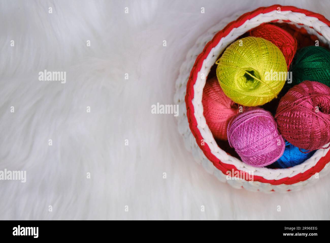Filati per uncinetto. Diverse palline di lana multicolore di filo in cesto  di vimini su sfondo bianco soffice. Vista dall'alto, banner Web con spazio  di copia. Co Foto stock - Alamy