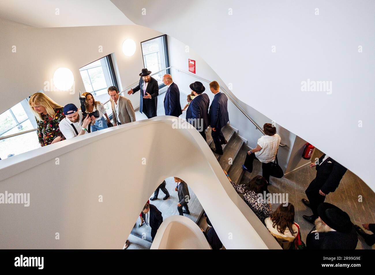 25 giugno 2023, Berlino: Kai Wegner, sindaco di Berlino, Rabbi Yehuda Teichtal, Trevor Pears (M), membro del Consiglio di amministrazione della Pears Foundation, e gli ospiti prendono parte al tour dopo la cerimonia di apertura del Pears Jewish Campus (PJC) nell'edificio. La più grande istituzione ebraica per l'istruzione, la cultura e lo sport da quando la Shoah ha aperto a Berlino con una festa di strada. Il Pears Jewish Campus di Wilmersdorf offre 8.000 metri quadrati di asilo nido, scuola elementare e superiore, studi artistici e studi musicali, un cinema da 100 posti e una sala per eventi sportivi. Foto: Carsten Koall/dpa Foto Stock