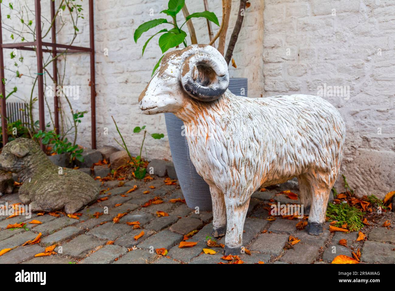 Statuetta di ariete singola in un giardino, autentica decorazione del giardino Foto Stock