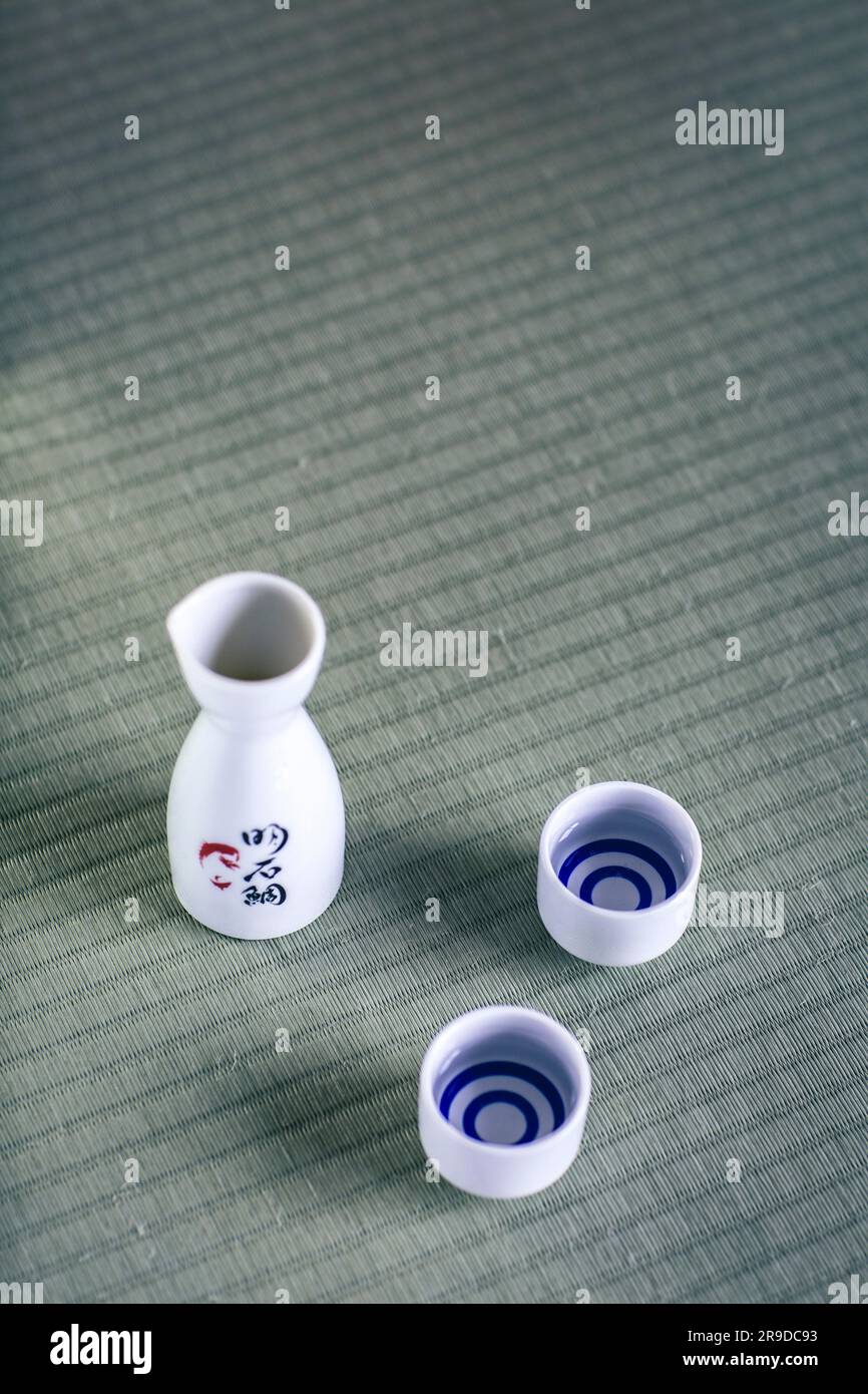 Tazze e bottiglia di sake tradizionali giapponesi, il sake è un liquore giapponese fatto con riso fermentato. Foto Stock