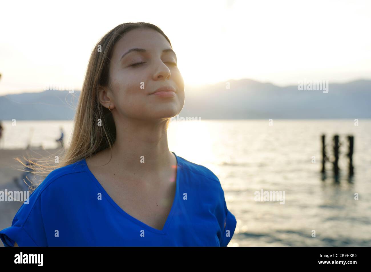 Ritratto di una donna meditativa che respira al tramonto. Spiritualità, purezza e pace. Foto Stock
