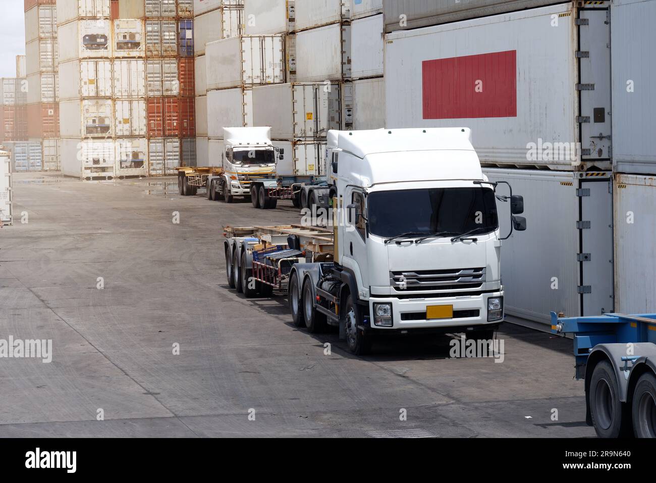 Carrelli nel deposito container nell'area di importazione ed esportazione al porto. Foto Stock