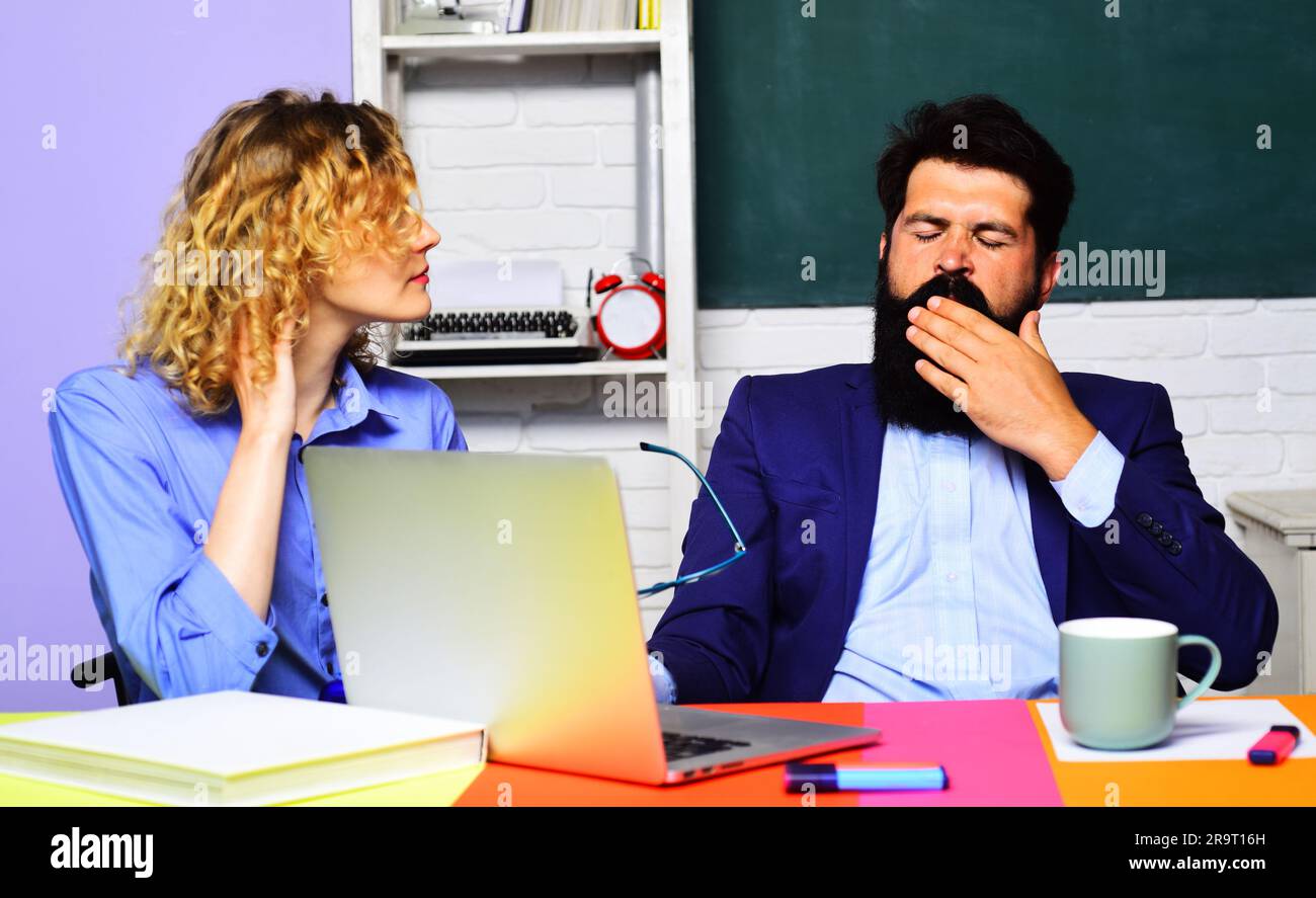 Lavoro da insegnante. Insegnanti maschili e femminili in classe. Insegnanti stanchi e sovraccarichi di lavoro o professori universitari sul posto di lavoro. Coppia di studenti affaticati Foto Stock